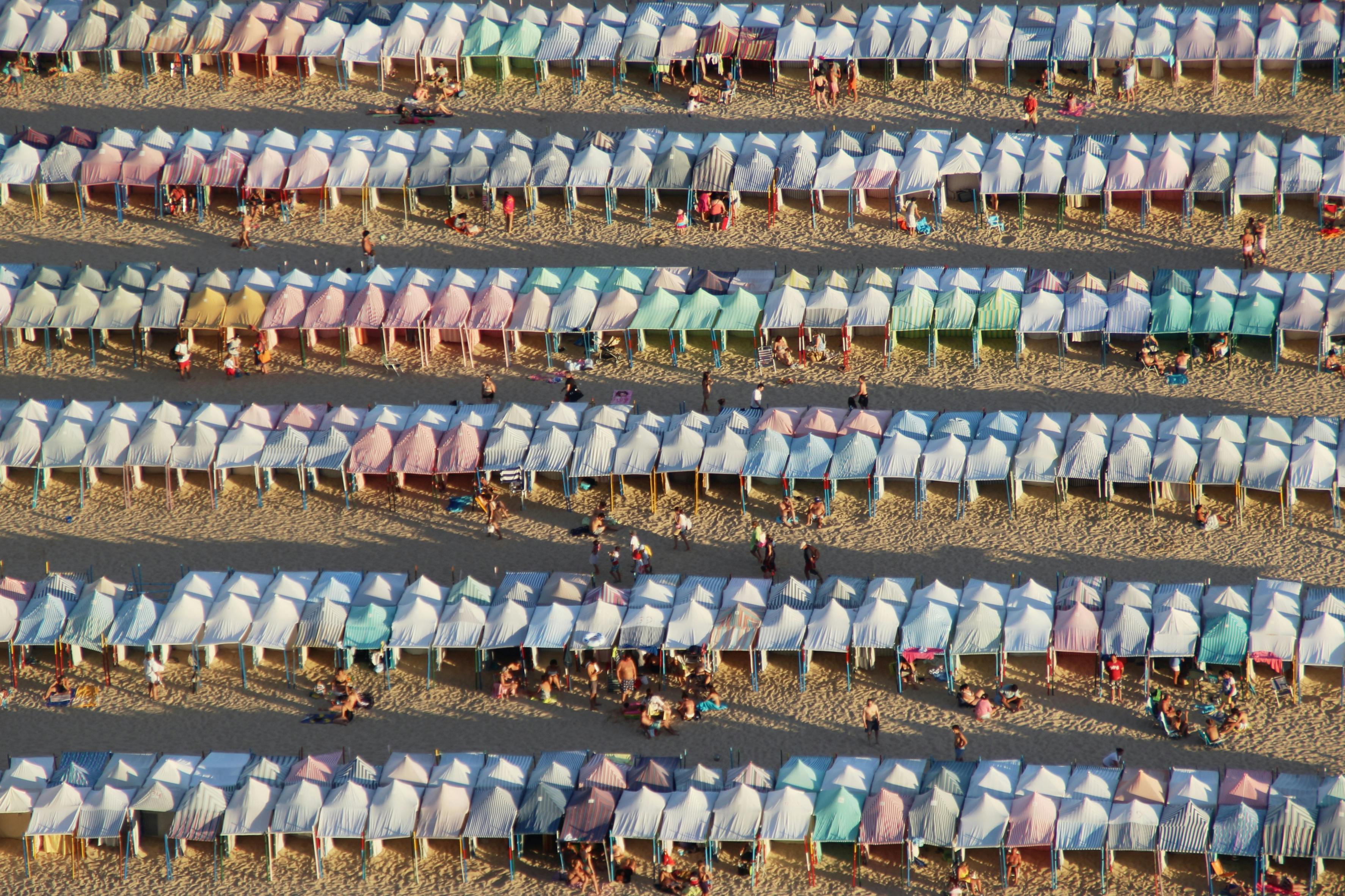 Person planning vacation, comparing brochures of different all-inclusive resorts